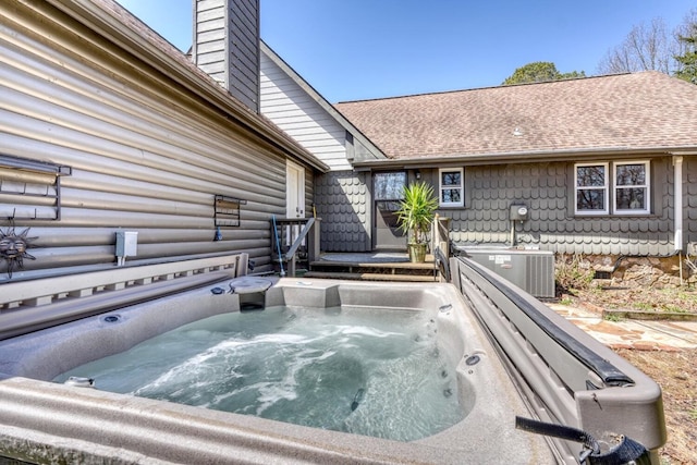 exterior space with a jacuzzi and central AC