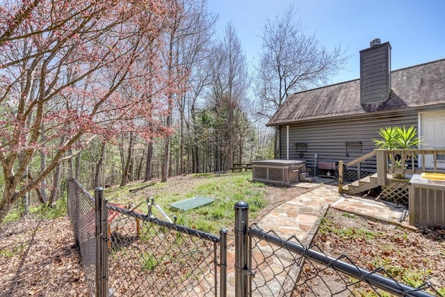 view of yard featuring a deck and a hot tub