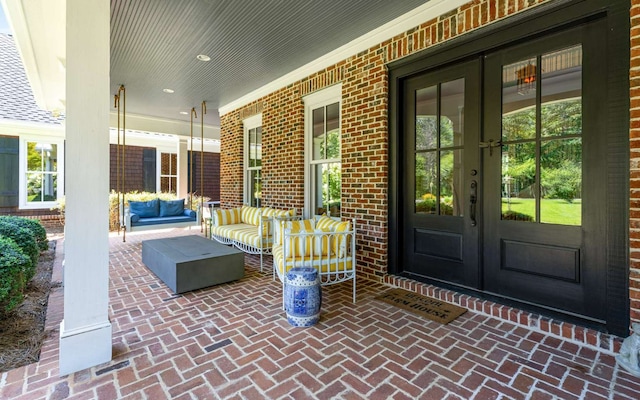 view of patio / terrace with french doors and a porch