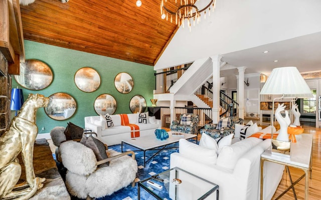 living room featuring high vaulted ceiling, wood ceiling, hardwood / wood-style floors, ornate columns, and an inviting chandelier