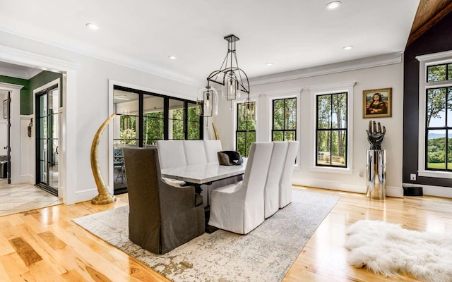 tiled dining room featuring ornamental molding and a chandelier