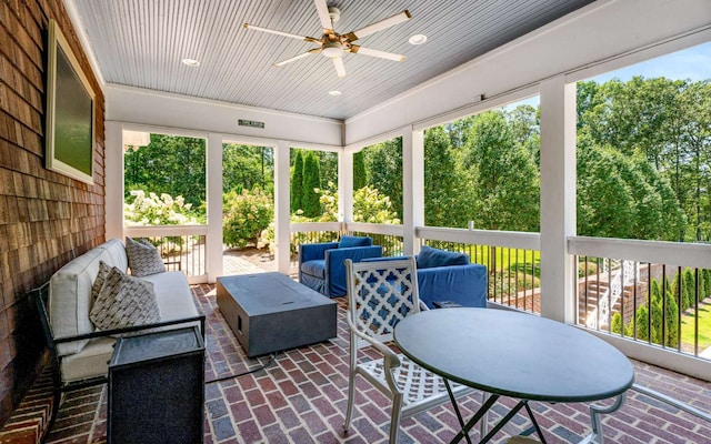 sunroom featuring ceiling fan