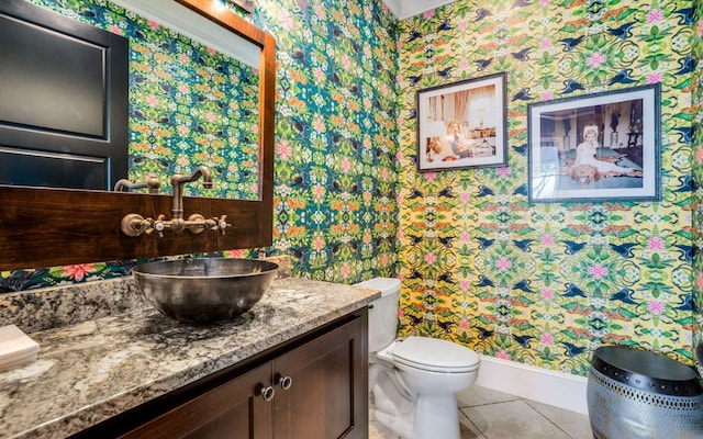 bathroom with toilet, tile floors, and vanity