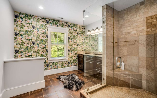 bathroom with walk in shower, tile flooring, and vanity