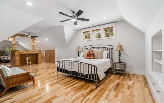 bedroom with ceiling fan, light hardwood / wood-style flooring, and vaulted ceiling