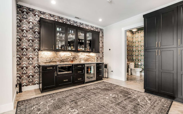 bar with backsplash, crown molding, wine cooler, and light stone counters