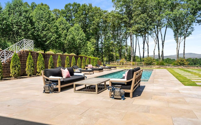 view of patio with a fenced in pool and an outdoor hangout area