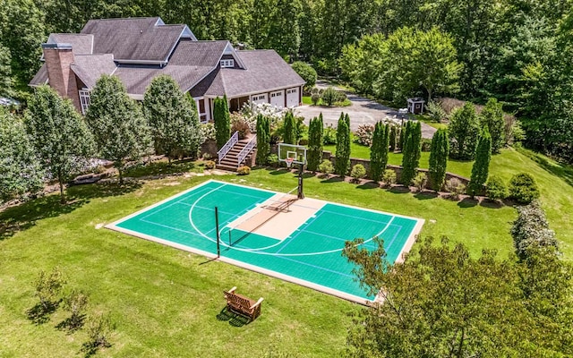 view of sport court featuring a yard