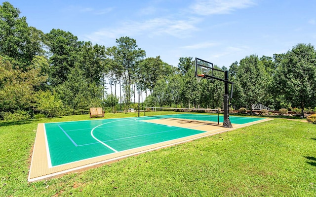 view of basketball court with a yard