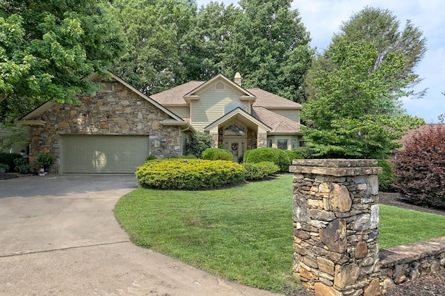 view of front facade with a chimney, an attached garage, stone siding, driveway, and a front lawn