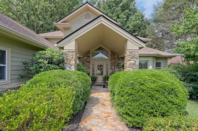 doorway to property with stone siding