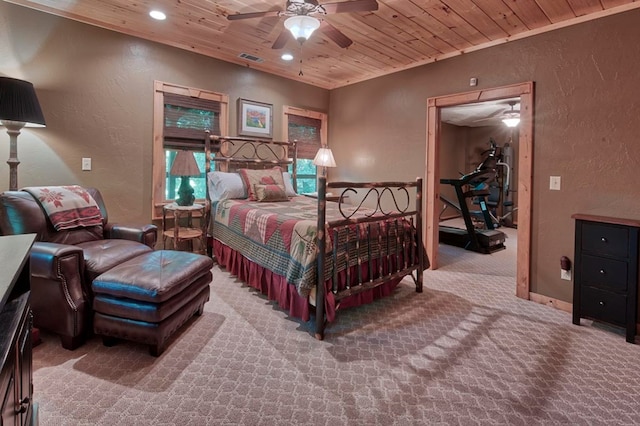 carpeted bedroom featuring a textured wall, recessed lighting, visible vents, baseboards, and wood ceiling