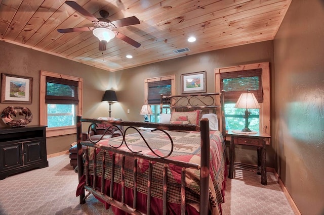 bedroom featuring light carpet, wooden ceiling, visible vents, and baseboards