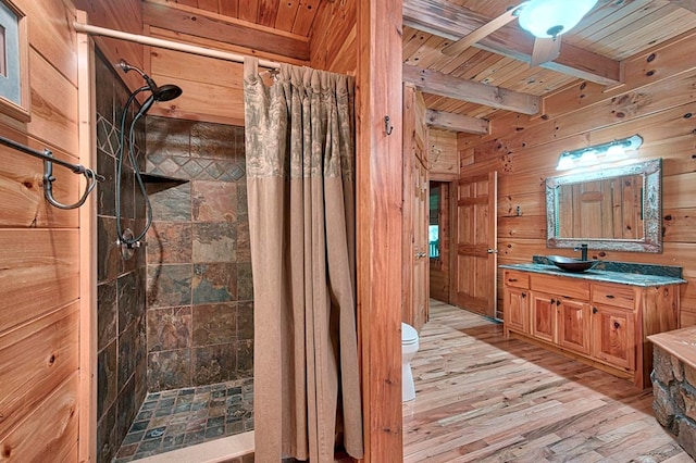 full bathroom with wooden ceiling, wood walls, wood finished floors, a stall shower, and beamed ceiling