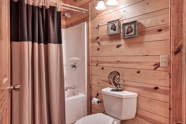 full bathroom with toilet, wood walls, and shower / bath combo with shower curtain