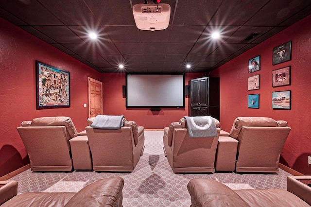 carpeted home theater room with recessed lighting, a drop ceiling, and baseboards