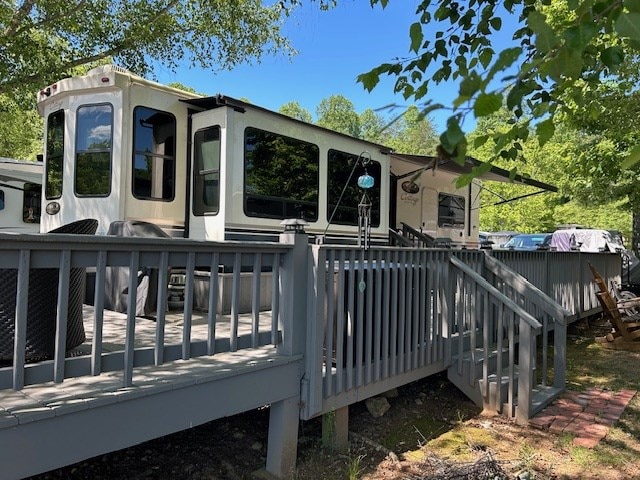 rear view of house with a wooden deck