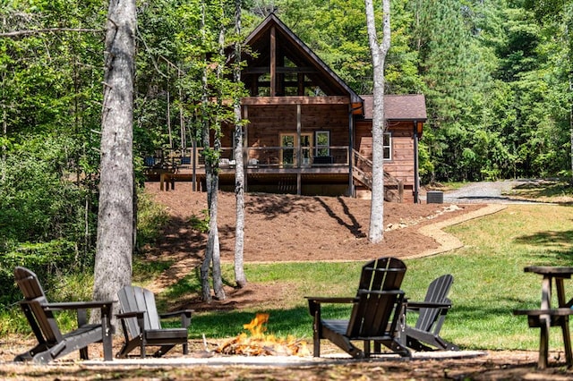 exterior space featuring a yard, an outdoor fire pit, and a deck