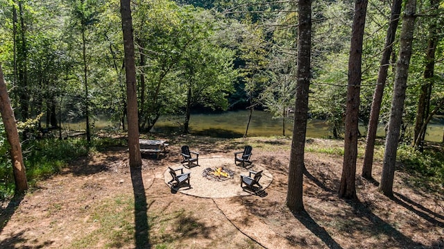 view of yard featuring a fire pit and a water view