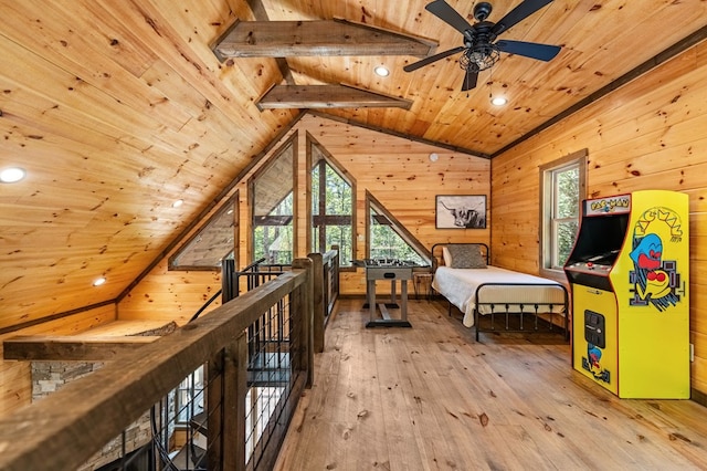 bedroom with wooden ceiling, lofted ceiling with beams, light hardwood / wood-style flooring, and wooden walls