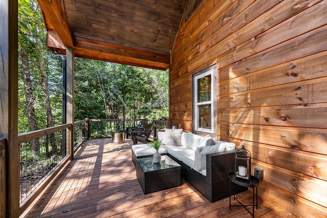 wooden deck with an outdoor living space