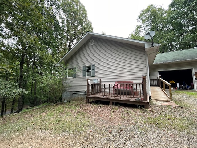 rear view of property featuring a deck