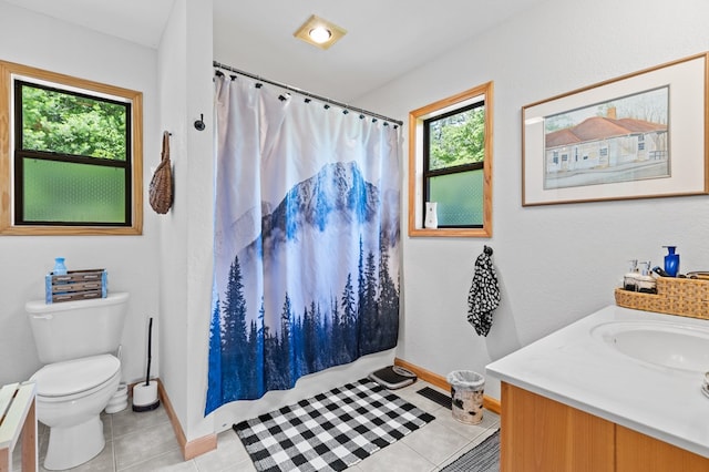 bathroom featuring tile patterned flooring, vanity, walk in shower, and toilet