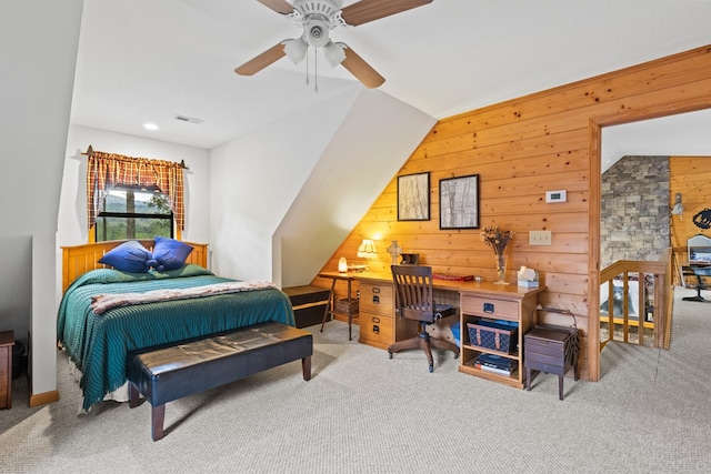 bedroom featuring vaulted ceiling, ceiling fan, carpet floors, and wood walls