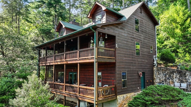 rear view of property featuring a balcony