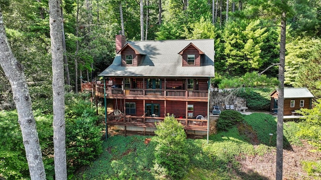 rear view of house featuring a wooden deck