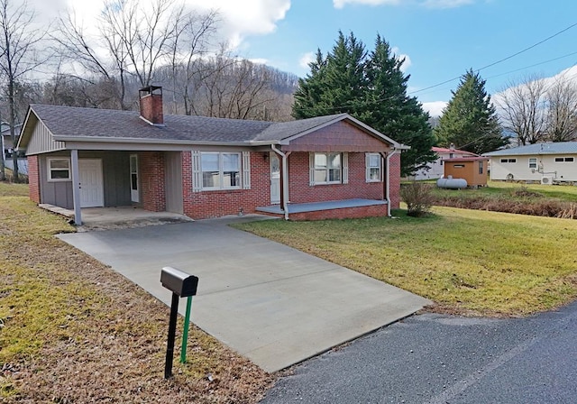 ranch-style house with a carport and a front lawn