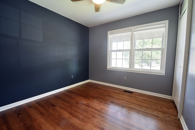 empty room featuring hardwood / wood-style floors and ceiling fan