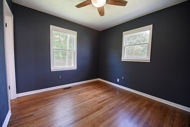 spare room with hardwood / wood-style floors and ceiling fan