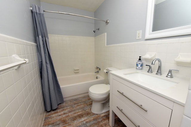 full bathroom featuring hardwood / wood-style floors, tile walls, vanity, toilet, and shower / bathtub combination with curtain