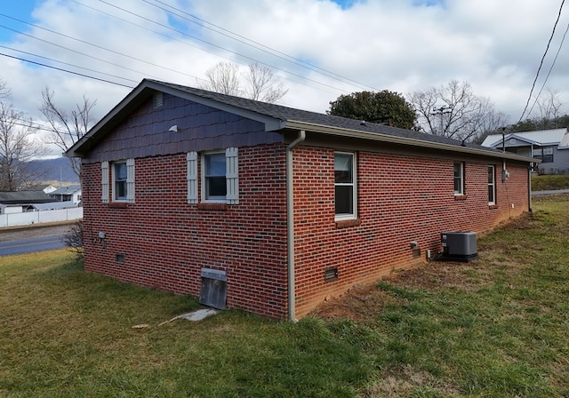 view of property exterior with cooling unit and a lawn