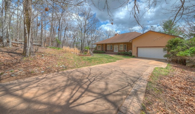 641/638 Timberwood Hills Rd, Murphy, NC 28906 - view of front of home featuring a garage, a chimney, a front yard, brick siding, and driveway