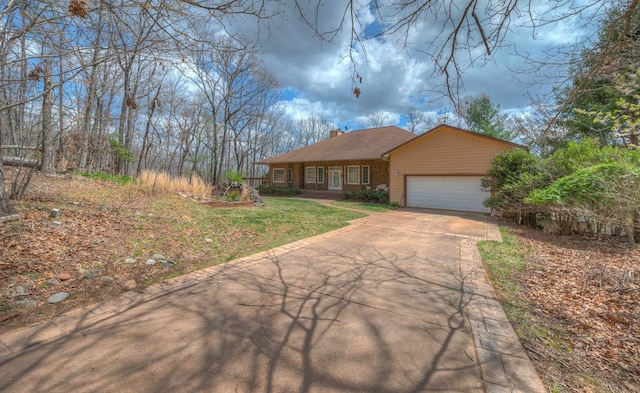 641/638 Timberwood Hills Rd, Murphy, NC 28906 - view of front facade with a chimney, brick siding, a garage, concrete driveway, and a front yard
