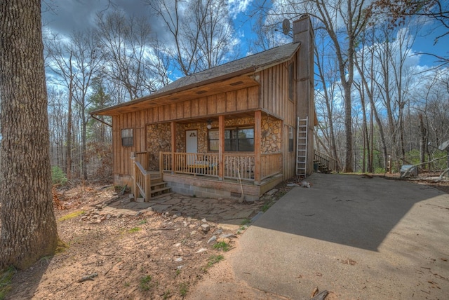 641/638 Timberwood Hills Rd, Murphy, NC 28906 - view of front of house featuring a porch, a shingled roof, and a chimney