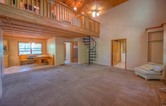 641/638 Timberwood Hills Rd, Murphy, NC 28906 - unfurnished living room featuring carpet, baseboards, ceiling fan with notable chandelier, stairs, and a high ceiling