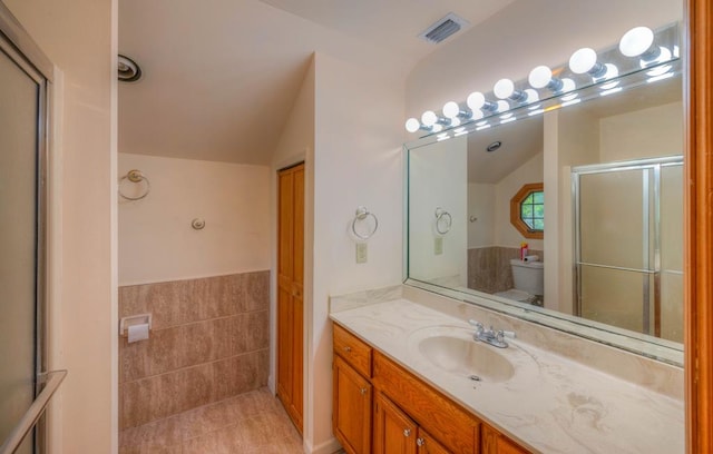 641/638 Timberwood Hills Rd, Murphy, NC 28906 - full bath with lofted ceiling, toilet, vanity, visible vents, and tile patterned floors