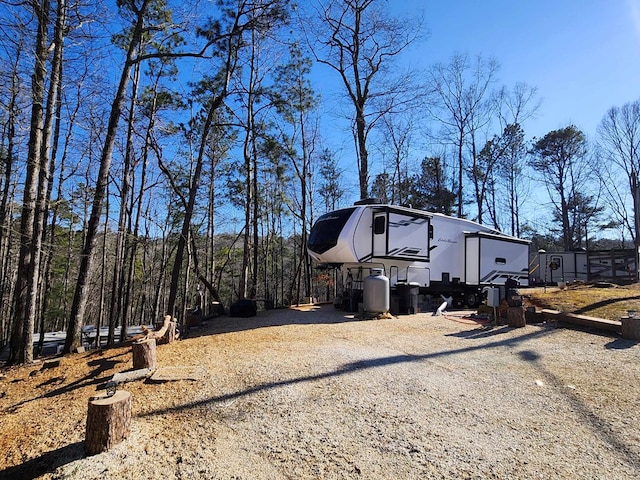 view of side of home featuring gravel driveway