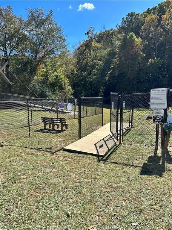 surrounding community featuring fence and a yard