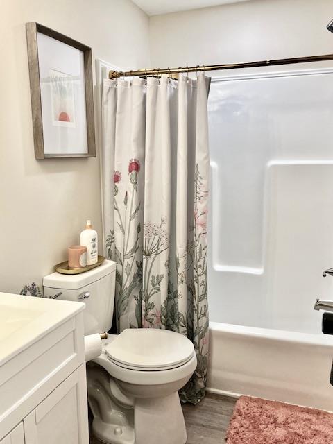 full bathroom with hardwood / wood-style flooring, vanity, toilet, and shower / bath combo