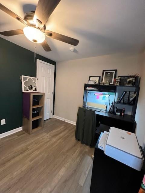 home office with wood-type flooring and ceiling fan