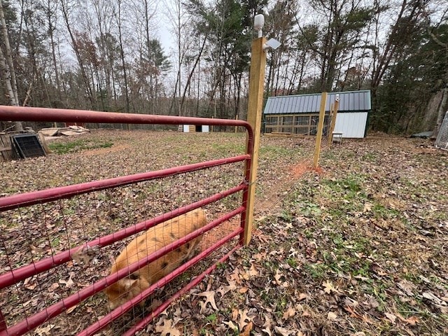 view of gate with an outbuilding