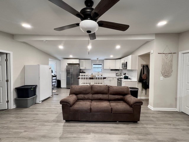 living room featuring ceiling fan and light hardwood / wood-style flooring