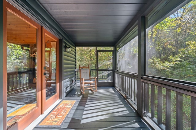 unfurnished sunroom with wooden ceiling