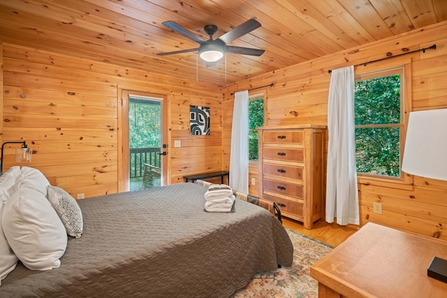 bedroom featuring access to exterior, ceiling fan, wood walls, wood-type flooring, and wood ceiling