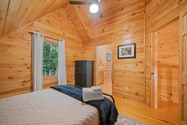 bedroom with wood walls, ceiling fan, wood ceiling, and vaulted ceiling