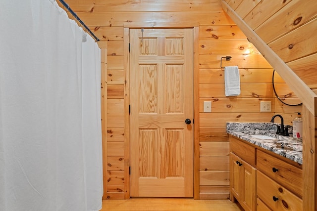 bathroom with wooden walls, vanity, wood-type flooring, and wooden ceiling